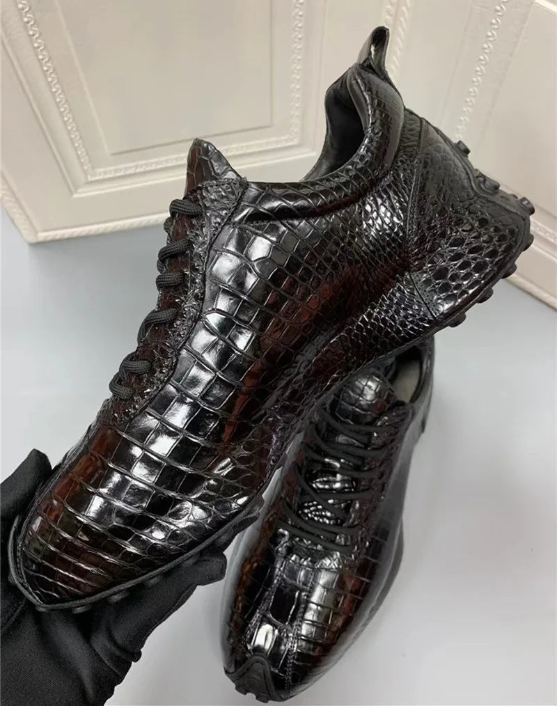 Side angle of men’s TREKHE crocodile leather mid-top sneakers on gray background